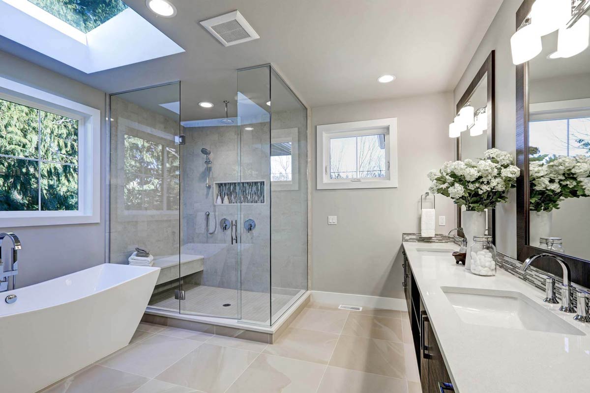 Luxury bathroom remodel featuring a walk-in shower with glass panels by Murrayhill Remodeling