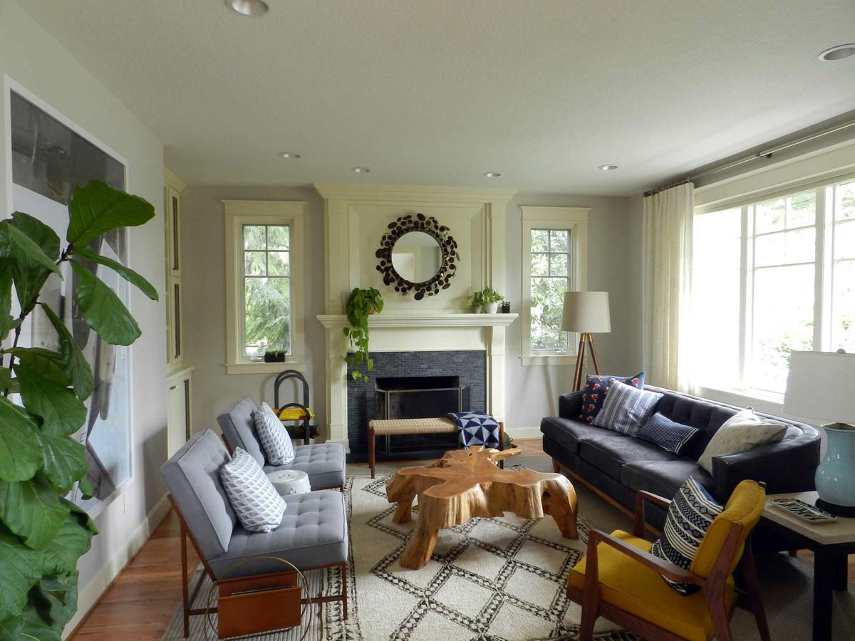 Warm family living room remodel with a custom wood mantle and decorative wooden table